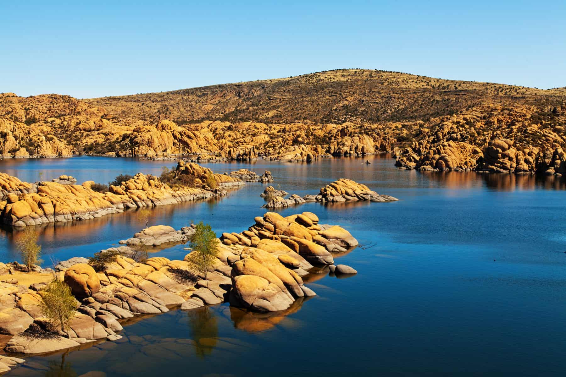 Scenic view of Watson Lake in Prescott, AZ, USA surrounded by majestic large red rock boulders and mountains