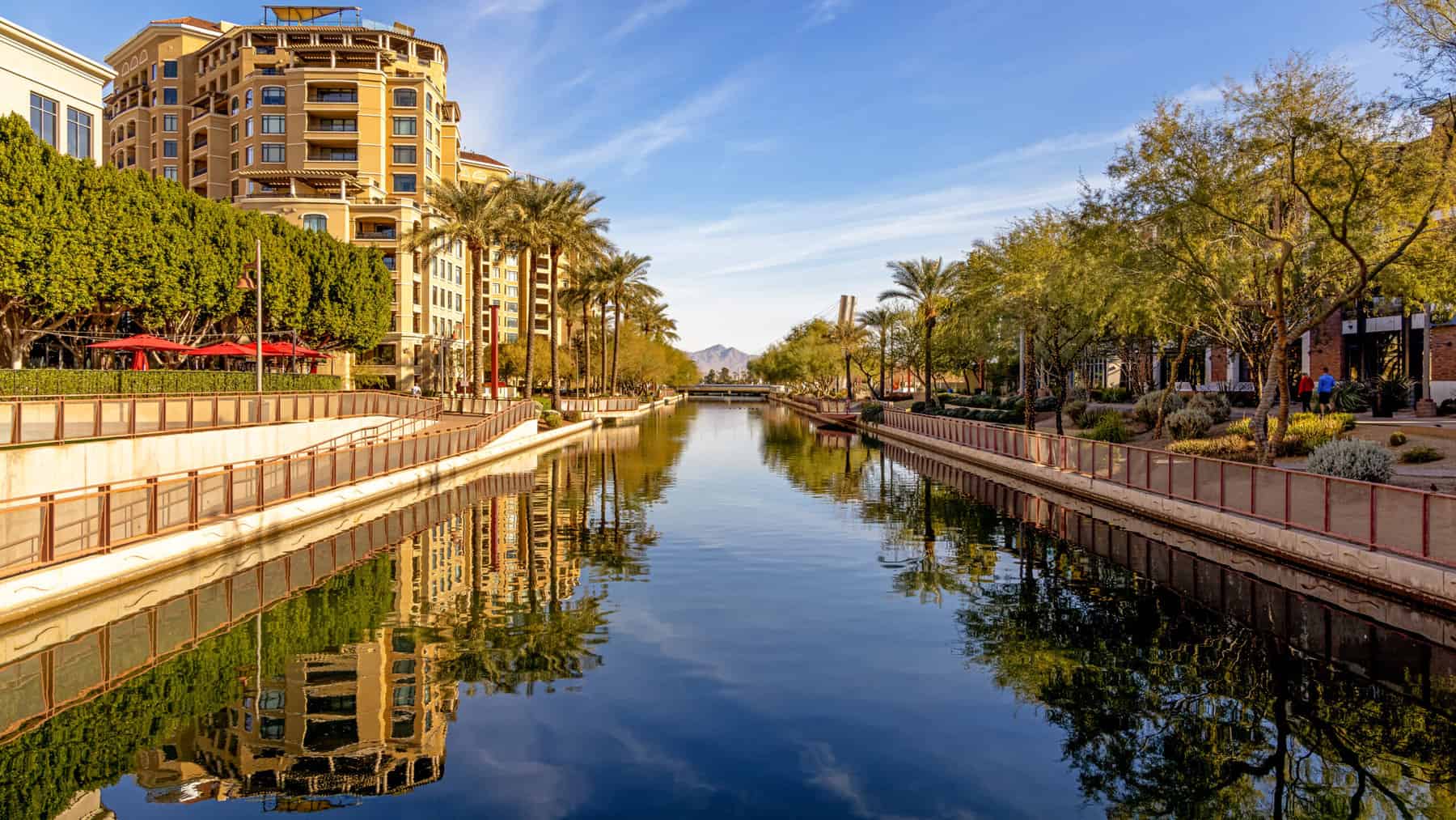 Daytime scene of canal running through waterfront district of Old Town Scottsdale, Arizona USA with condo housing, retail and restaurants