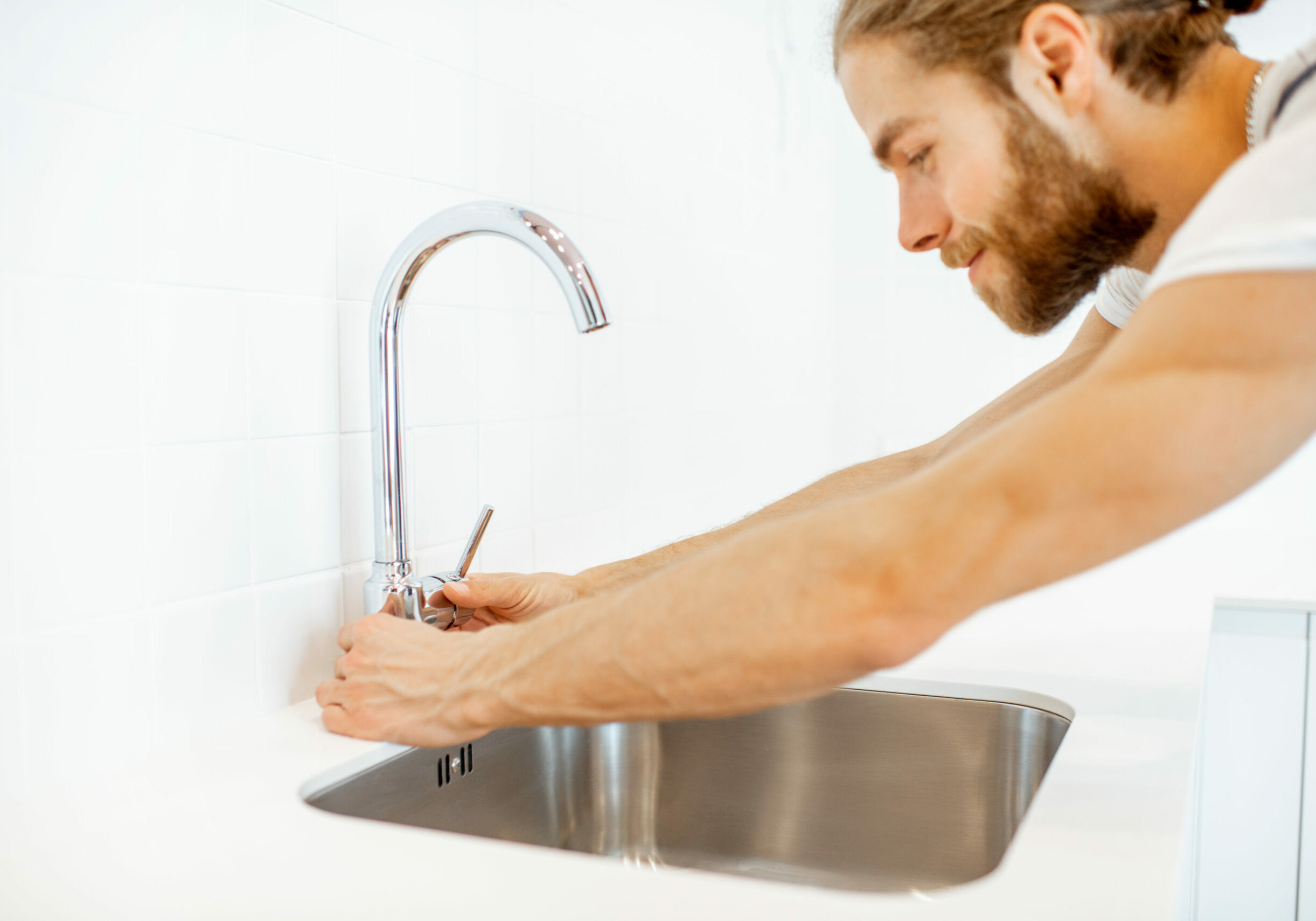 Workman installing kitchen faucet